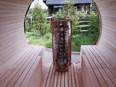 Wohlige Atmosphäre: In den vollständig aus Holz gefertigten Sauna-Fässern sitzt es sich urgemütlich und durch die Fenster lässt sich der Blick in den eigenen Garten genießen.